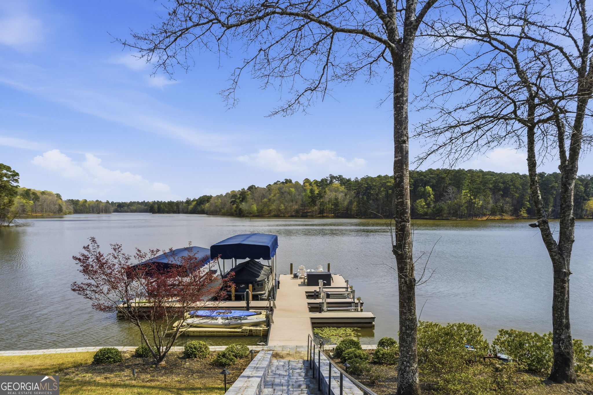 1060 Rdg Grv Court Greensboro, GA 30642 - Photo 2 of 68 a view of a lake with a table and chairs