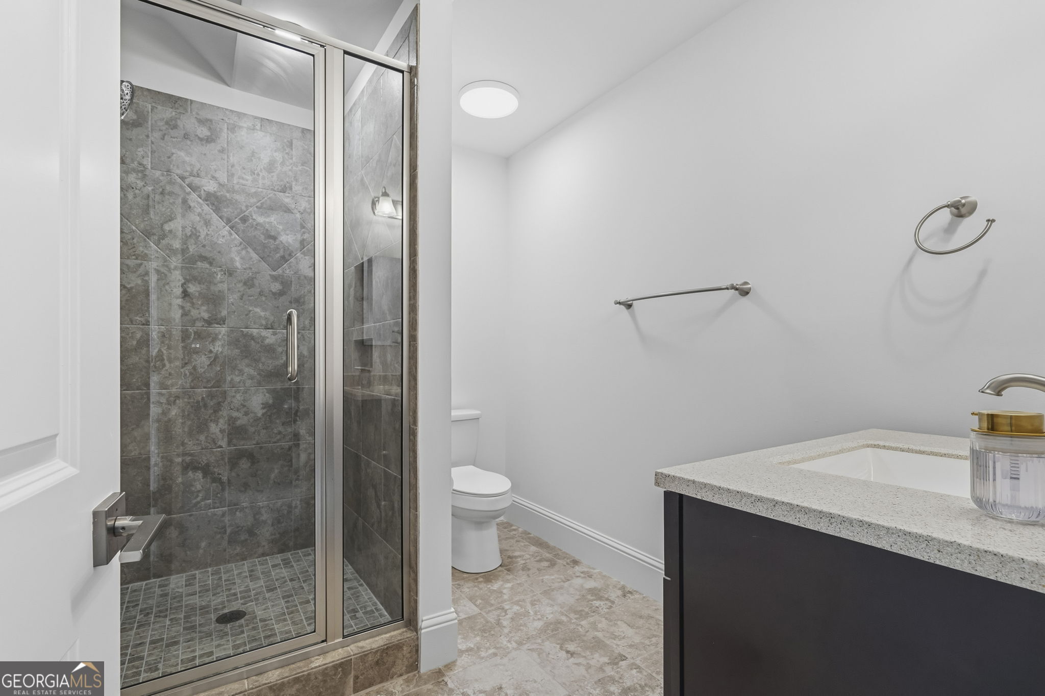 1060 Rdg Grv Court Greensboro, GA 30642 - Photo 57 of 68 a bathroom with a granite countertop sink a toilet and shower