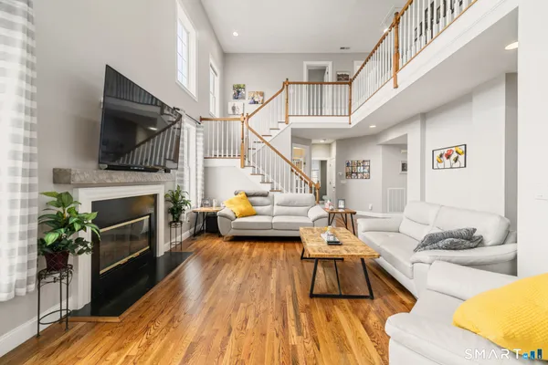 a living room with furniture fireplace and flat screen tv