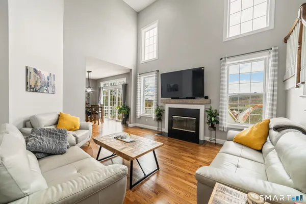 a living room with furniture a fireplace and a flat screen tv