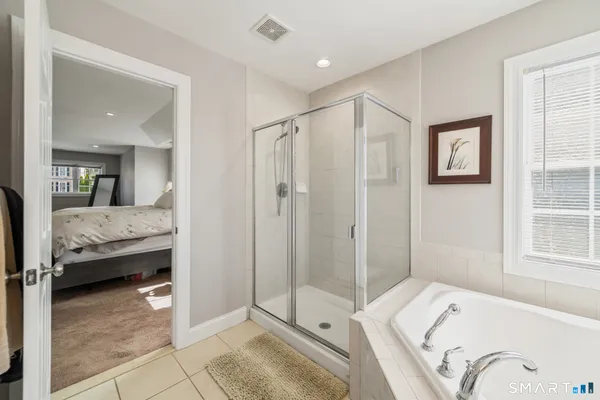 a bedroom with a bed and a mirror