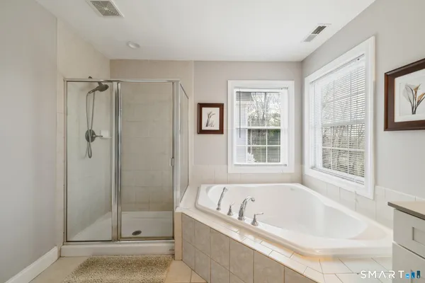 a bathroom with a bathtub and shower