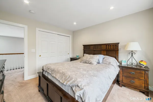 a bedroom with a bed and a night stand