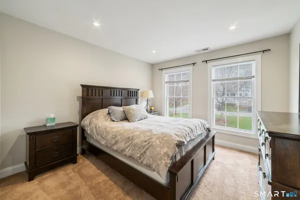 a bed sitting in a bedroom next to a window