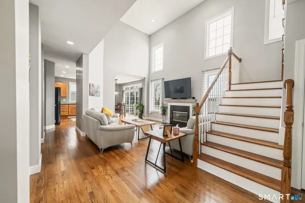 a living room with furniture a fireplace and a flat screen tv