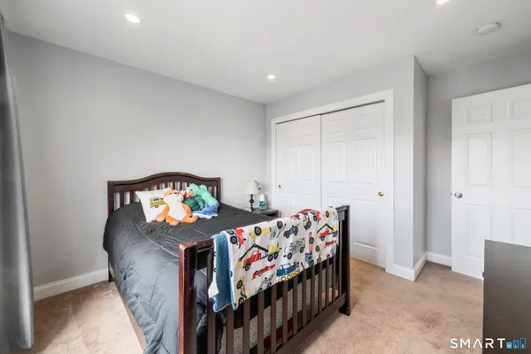 a bedroom with two beds and a bed