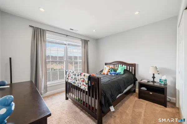 a bedroom with a bed and a window