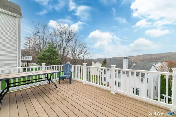 a view of a wooden deck with a yard