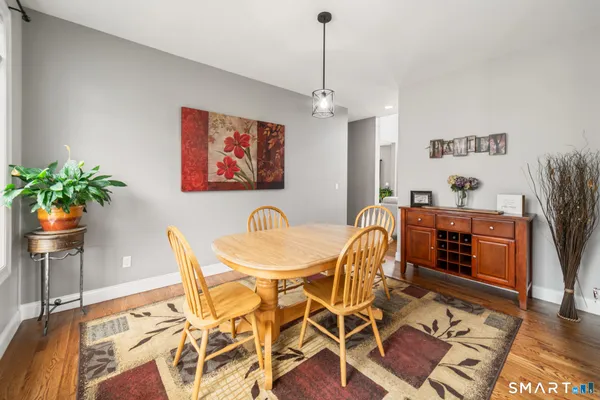 a view of a dining room with furniture and wooden floor