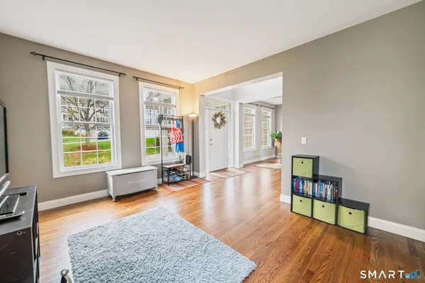 a living room with furniture and a wooden floor