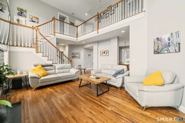 a living room with furniture and a wooden floor