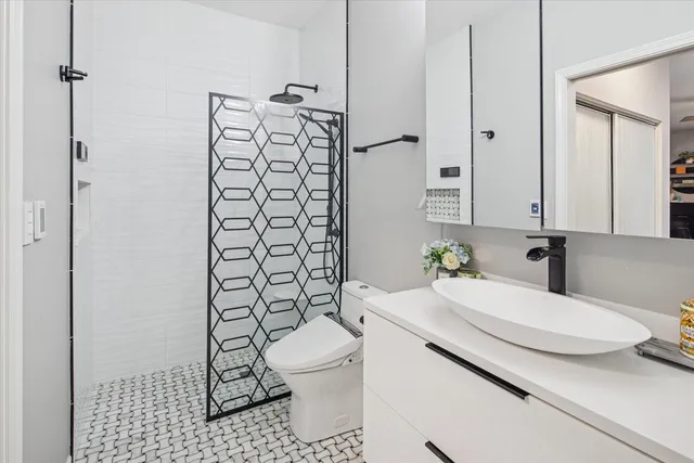 a bathroom with a sink toilet and shower