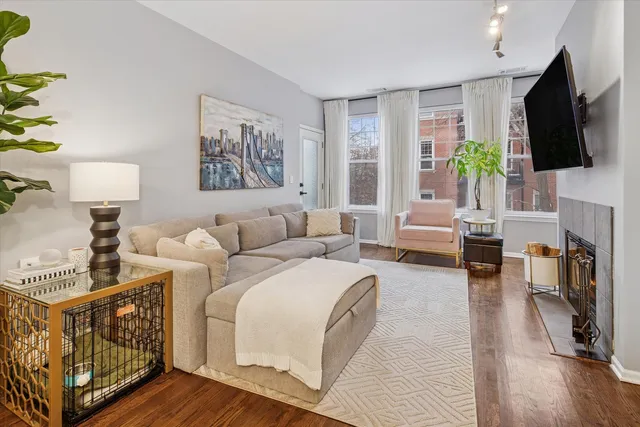 a living room with furniture a flat screen tv and a large window