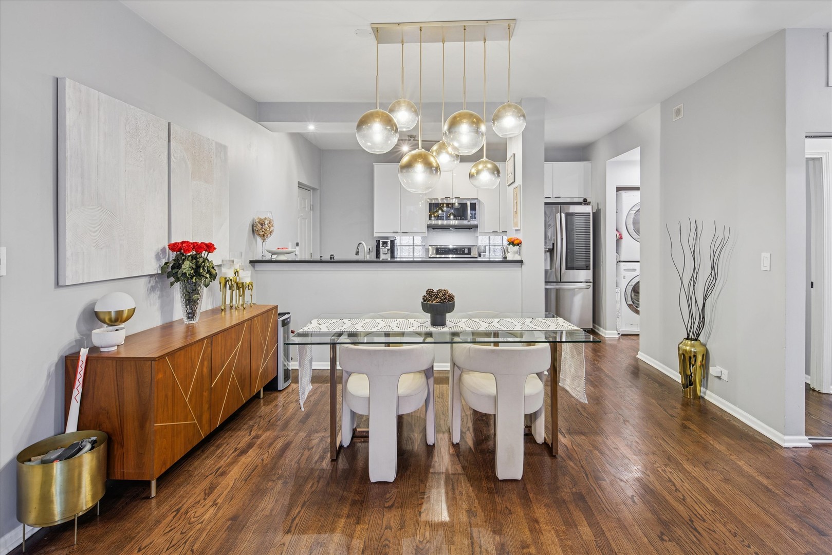 301 West Scott Street, Unit 103 Chicago, IL 60610 - Photo 5 of 17 a kitchen with kitchen island granite countertop wooden floors and wooden cabinets