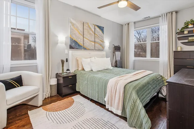 a bedroom with a bed couch and window