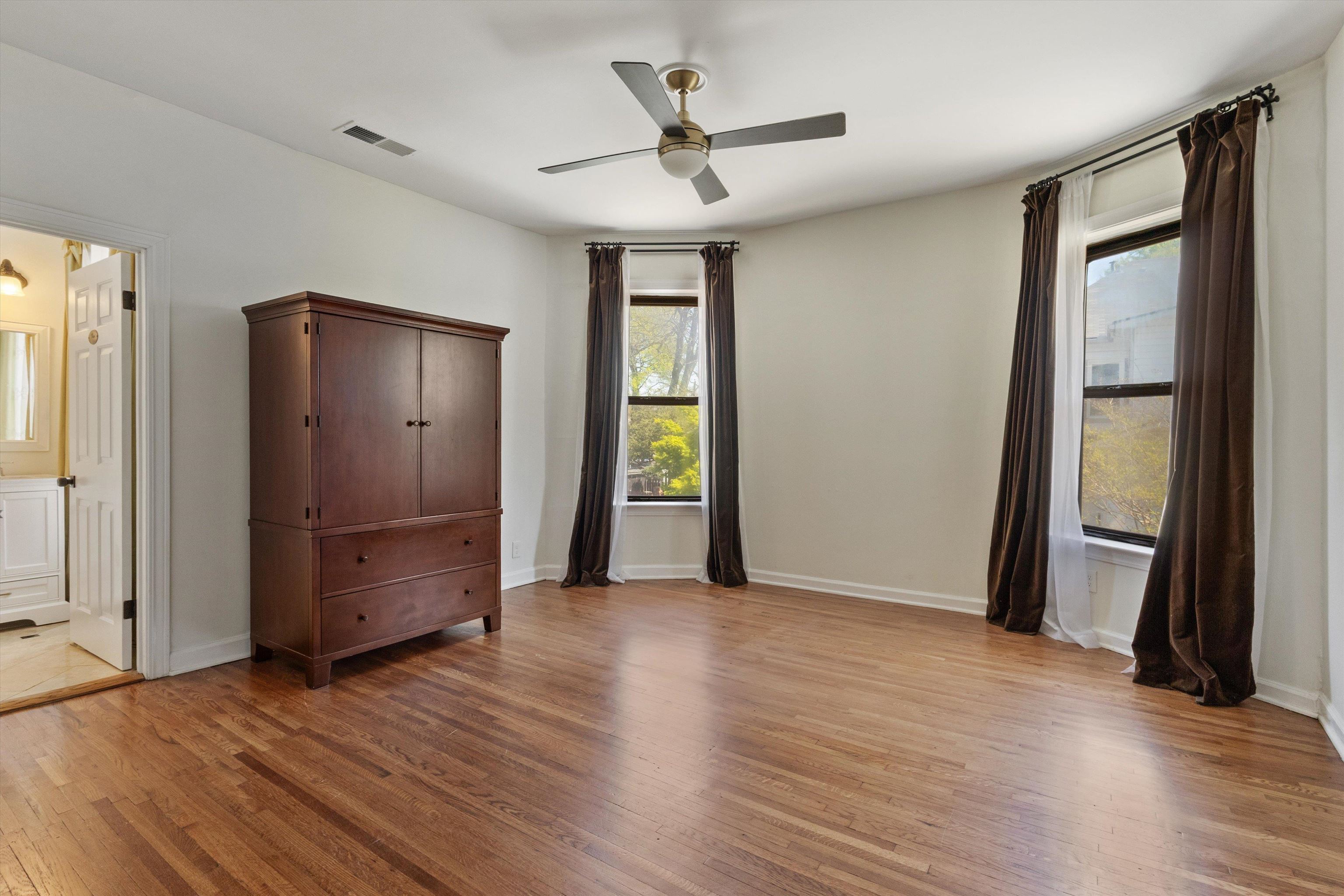 1680 Carruthers Place Memphis, TN 38112 - Photo 19 of 39 an empty room with wooden floor and a ceiling fan