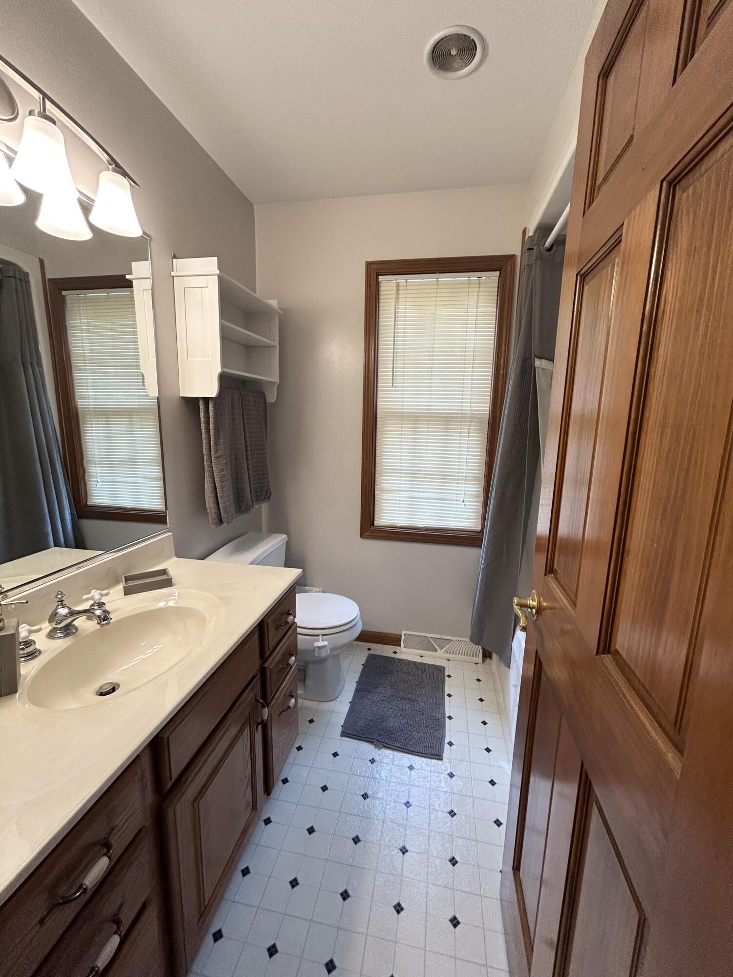 8876 North Lilac Street Demotte, IN 46310 - Photo 14 of 23 a bathroom with a sink a mirror and a toilet