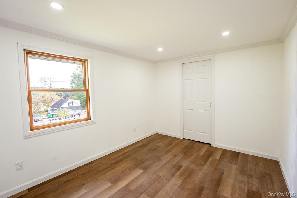 202 2nd Road Wappingers Falls, NY 12590 - Photo 20 of 24 Unfurnished room with recessed lighting, dark wood-type flooring, and ornamental molding