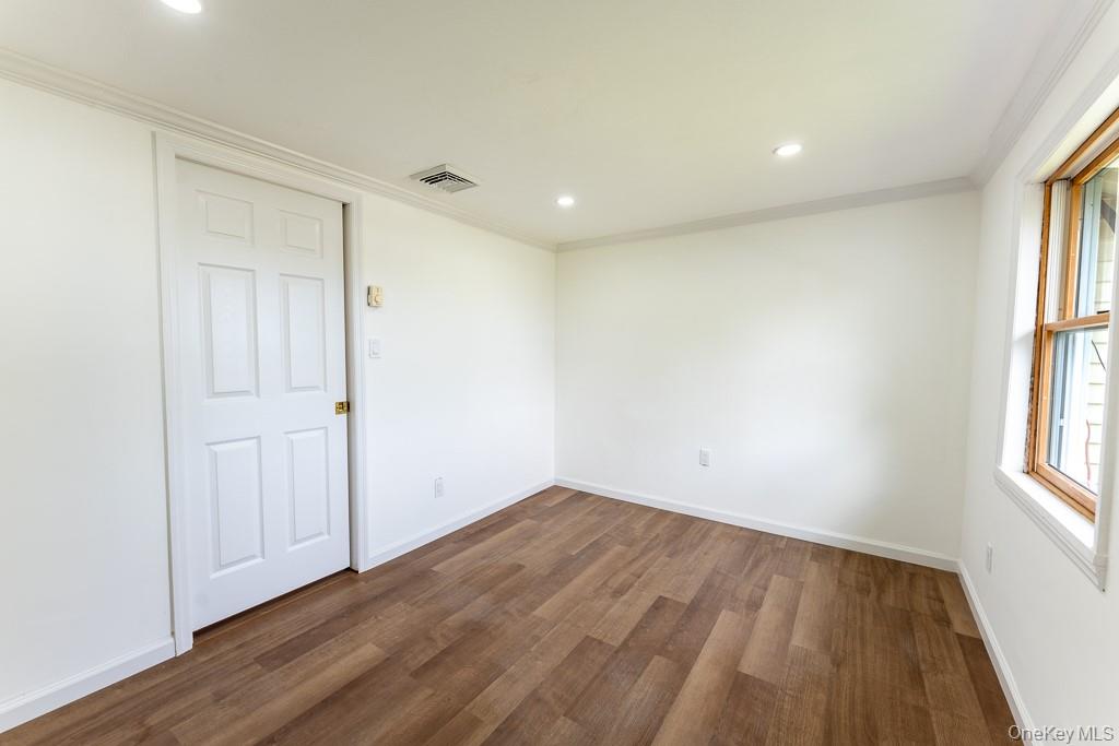202 2nd Road Wappingers Falls, NY 12590 - Photo 21 of 24 Spare room featuring dark wood-type flooring, ornamental molding, and recessed lighting