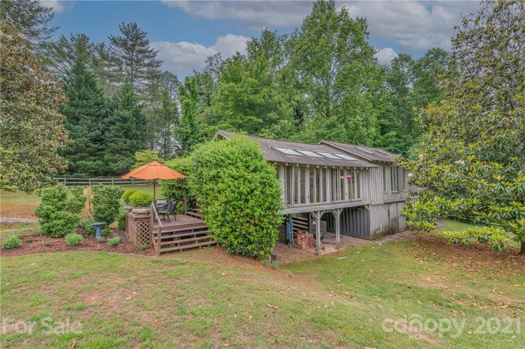 front view of a house with a yard and a fence