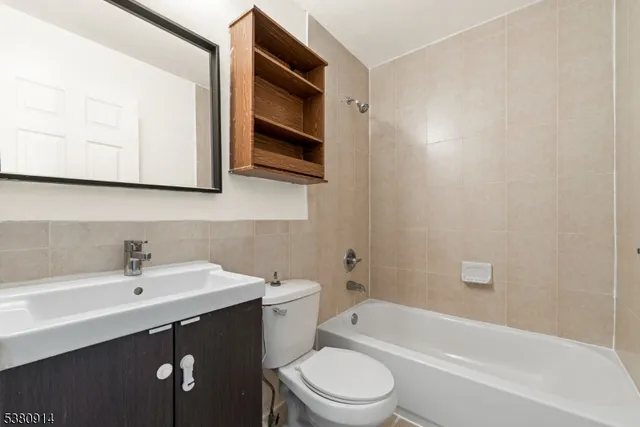 a bathroom with a sink a toilet and bathtub