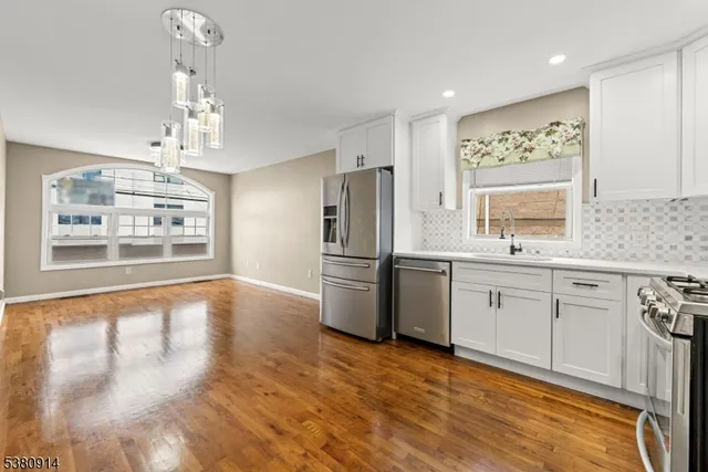 a kitchen with stainless steel appliances a refrigerator sink and stove