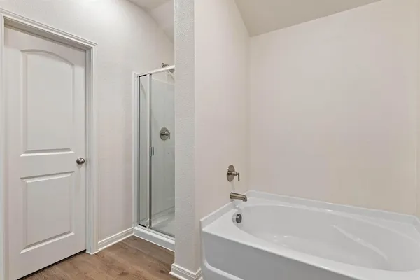 a white bath tub sitting next to a shower