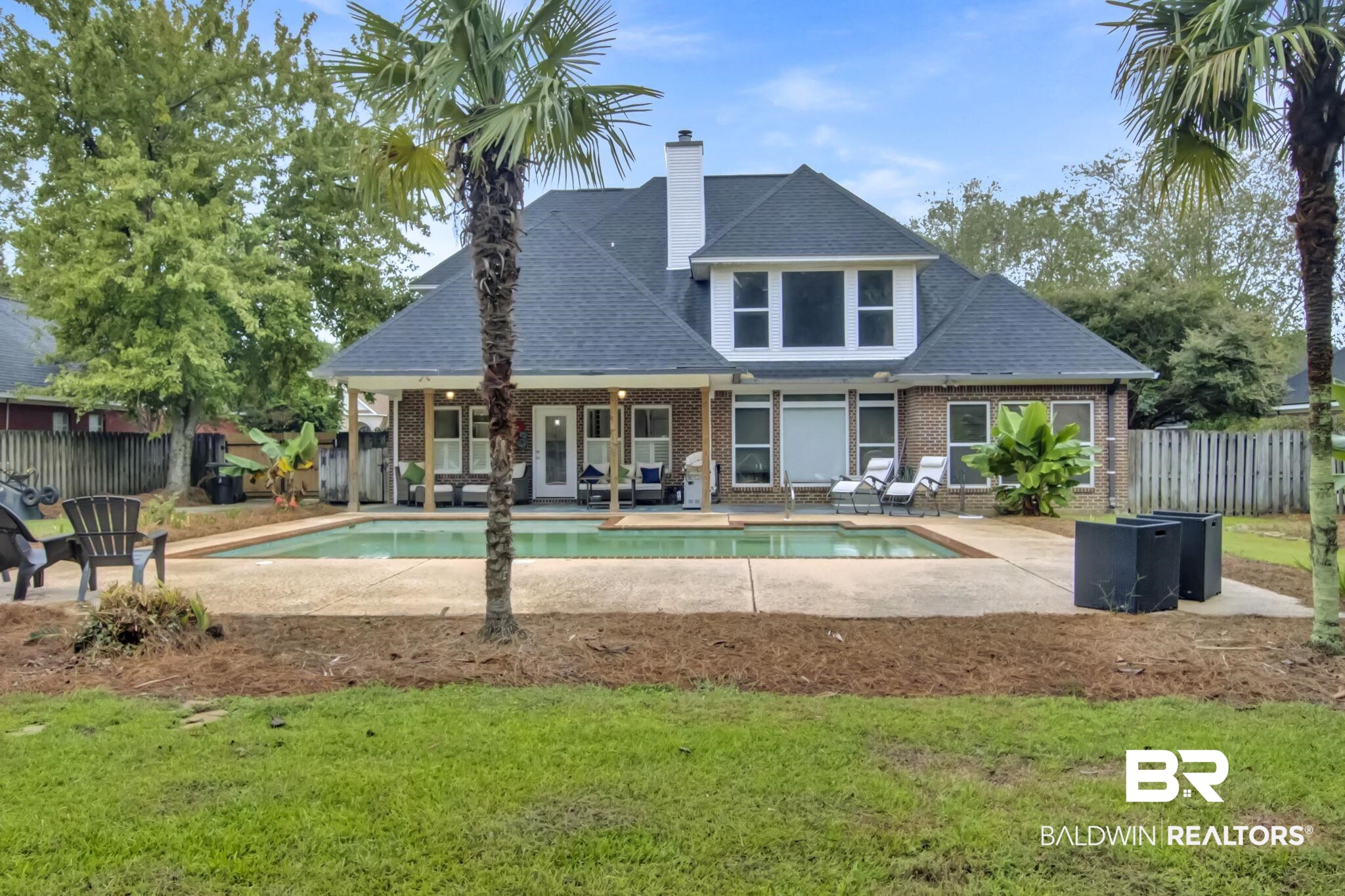 9002 Parliament Circle Daphne, AL 36526 - Photo 60 of 73 Back of property with a yard, a fenced in pool, and a patio area