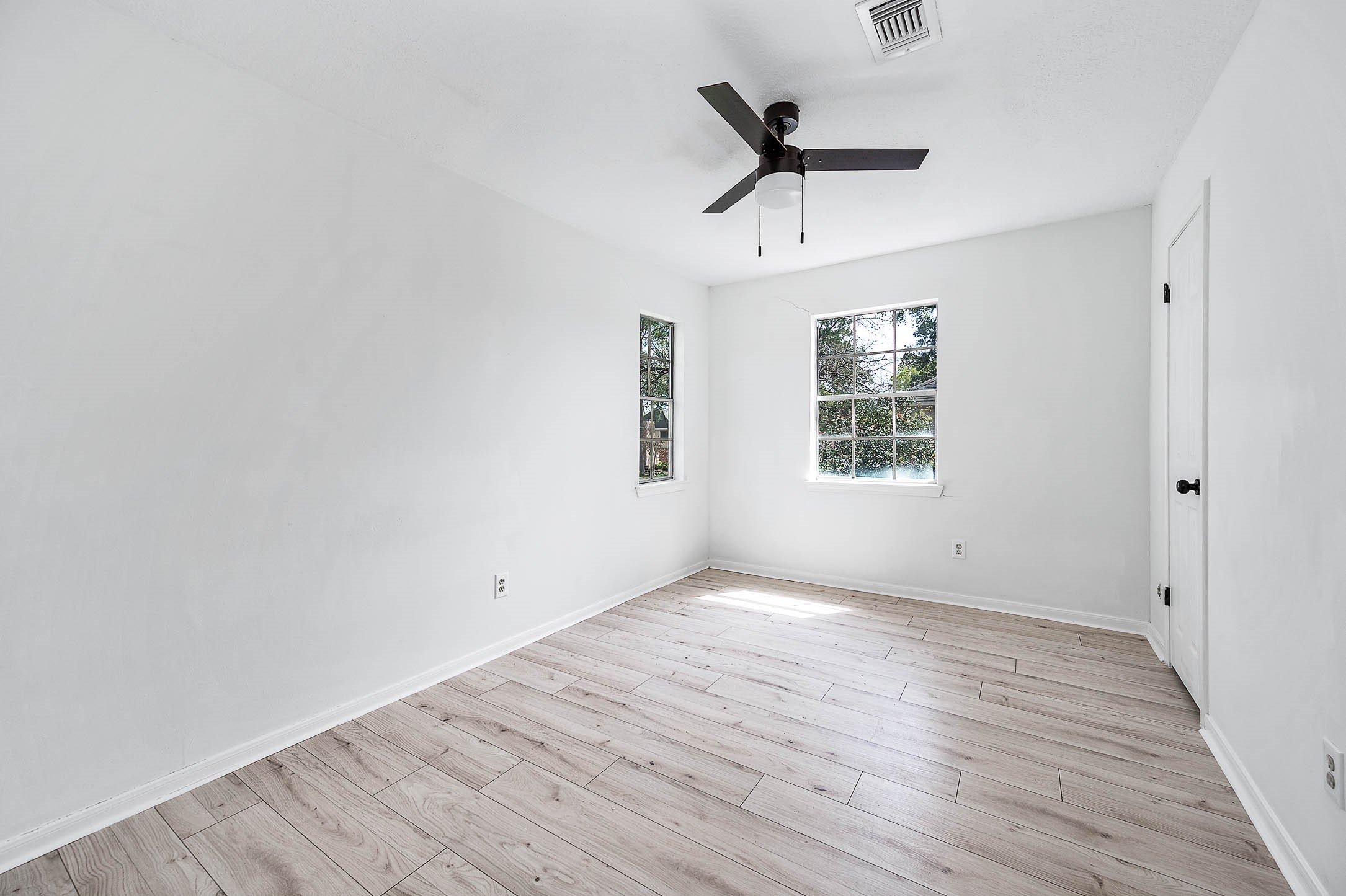 17627 Terrawren Lane Spring, TX 77379 - Photo 27 of 30 an empty room with wooden floor ceiling fan and windows