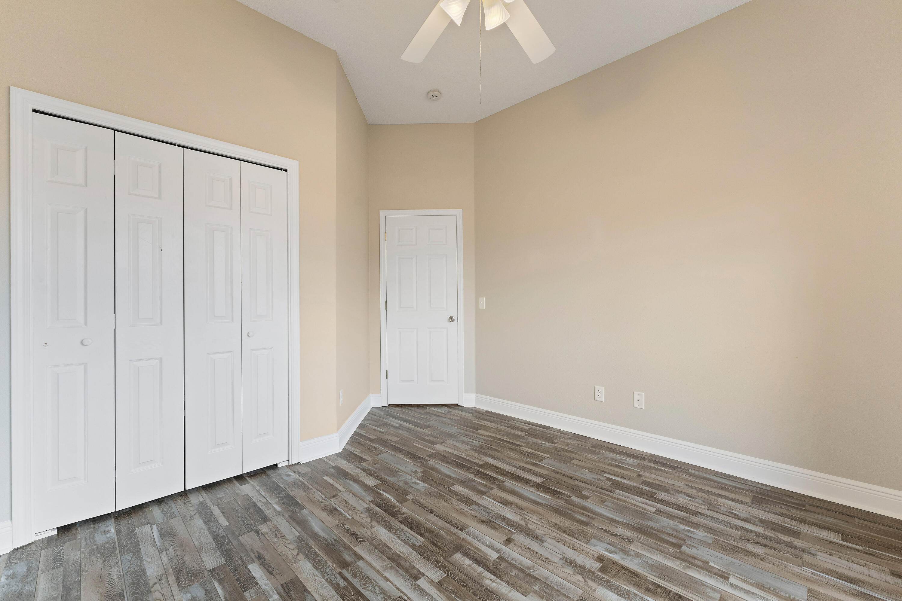 7162 Riverview Road Navarre, FL 32566 - Photo 12 of 33 a view of an empty room with wooden floor