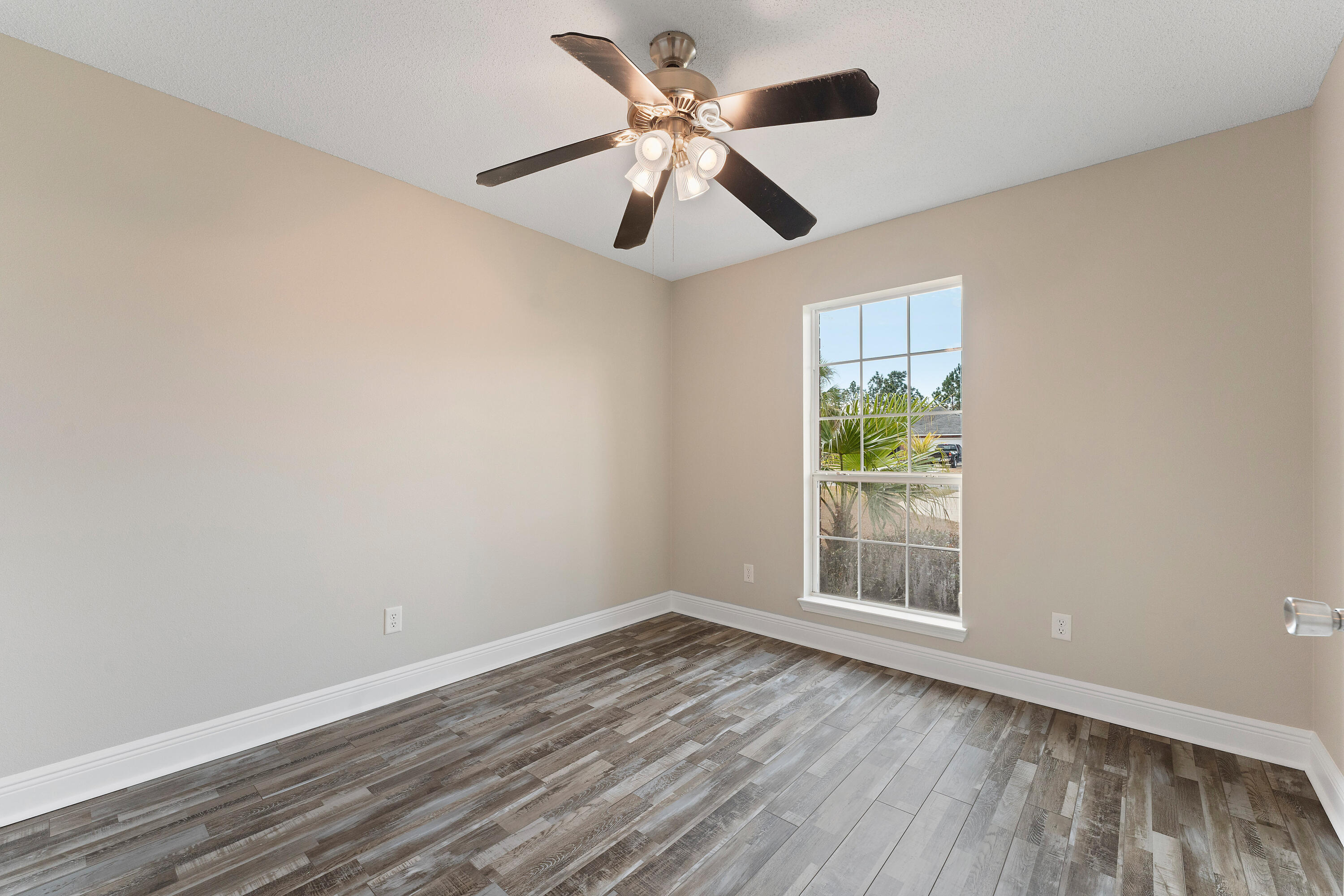 7162 Riverview Road Navarre, FL 32566 - Photo 13 of 33 wooden floor in an empty room with a window
