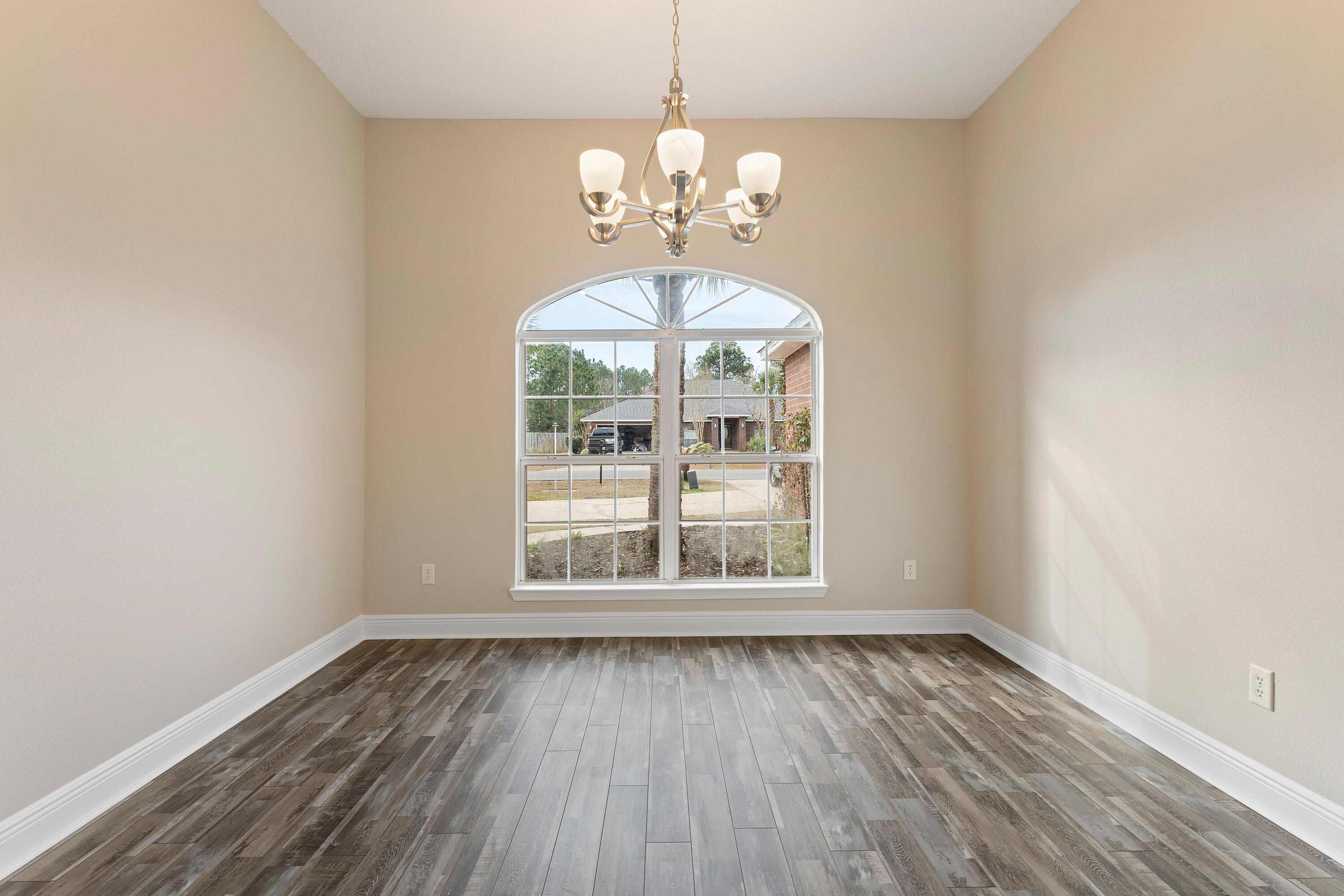 7162 Riverview Road Navarre, FL 32566 - Photo 18 of 33 an empty room with wooden floor and windows