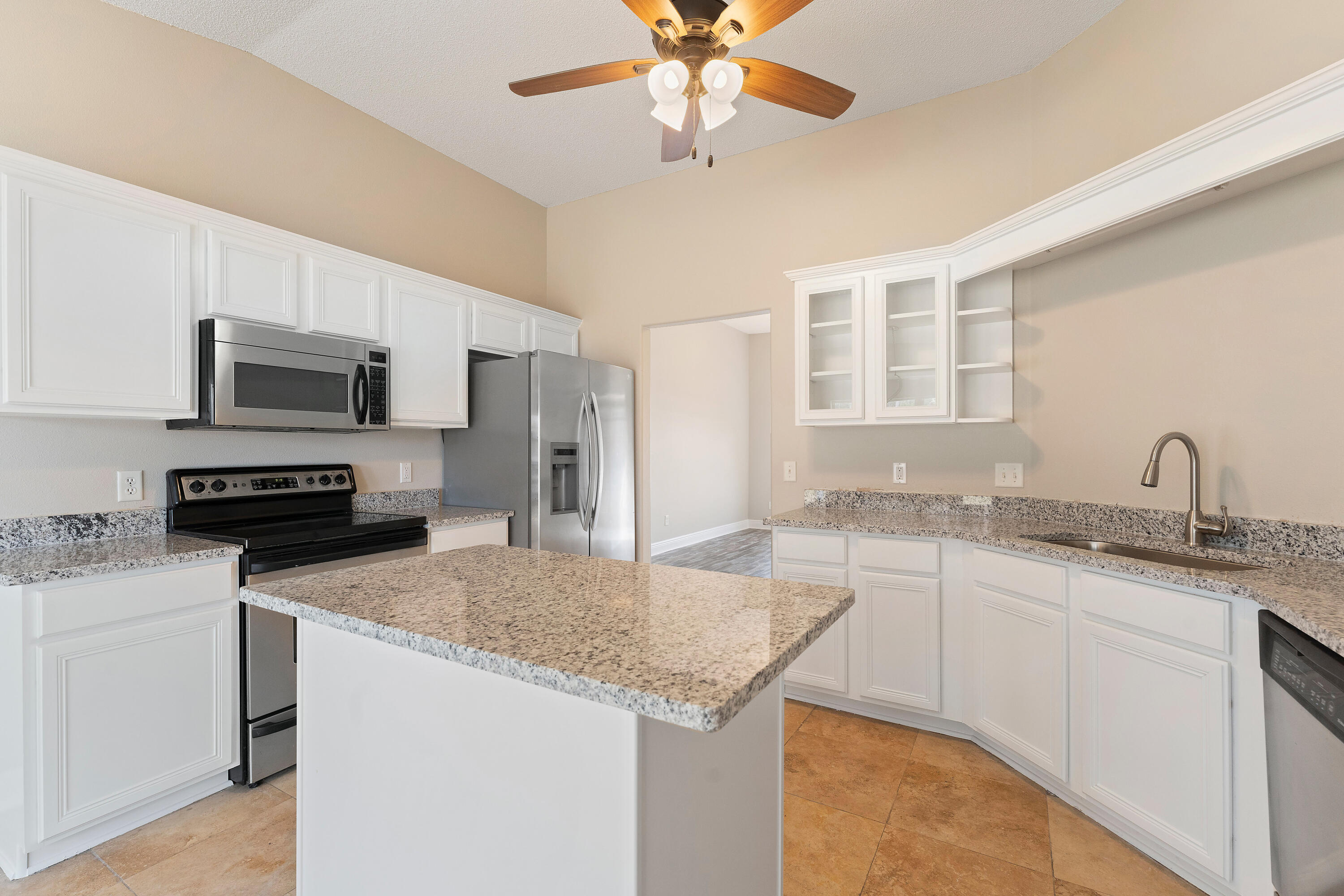 7162 Riverview Road Navarre, FL 32566 - Photo 28 of 33 a kitchen with granite countertop a sink stainless steel appliances and cabinets