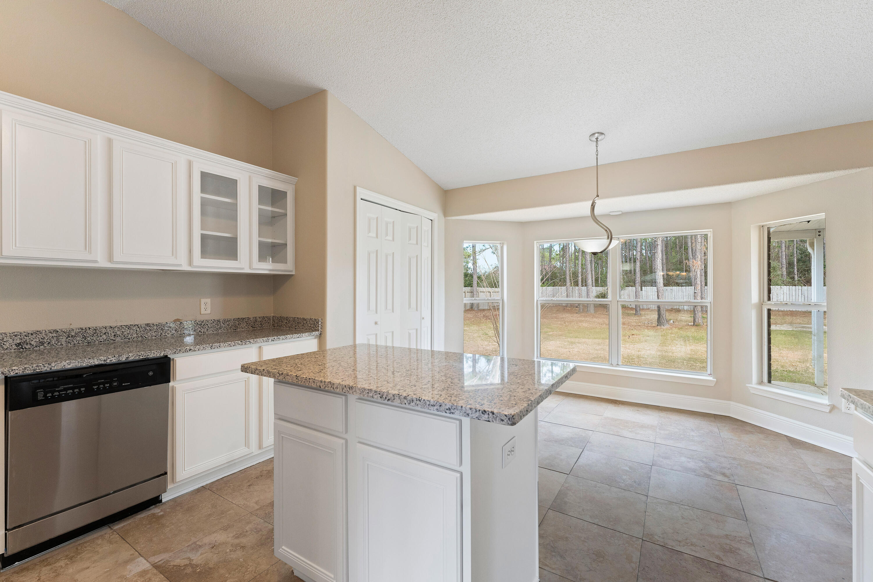 7162 Riverview Road Navarre, FL 32566 - Photo 29 of 33 a open kitchen with granite countertop a sink and white cabinets