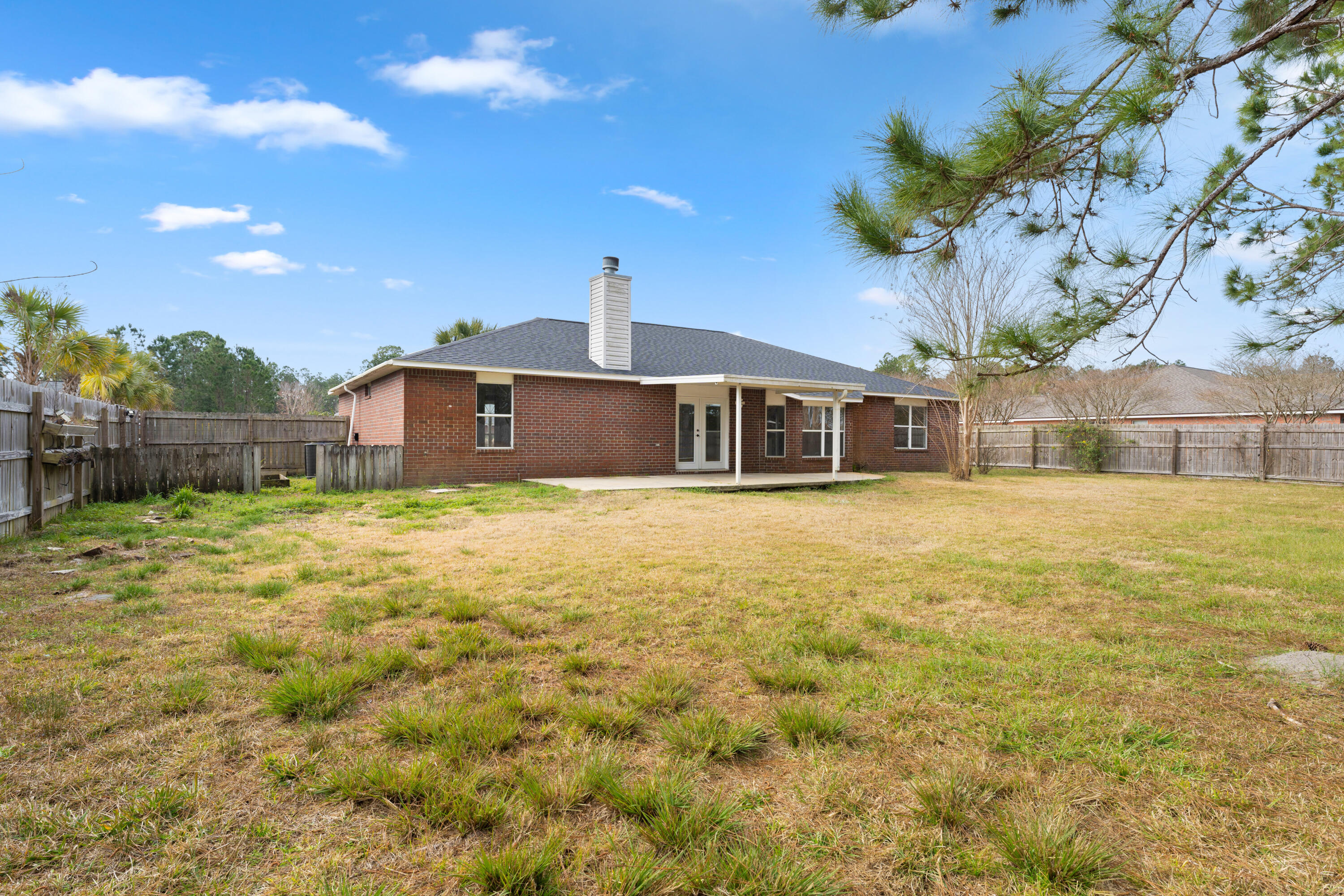 7162 Riverview Road Navarre, FL 32566 - Photo 31 of 33 a front view of a house with a garden