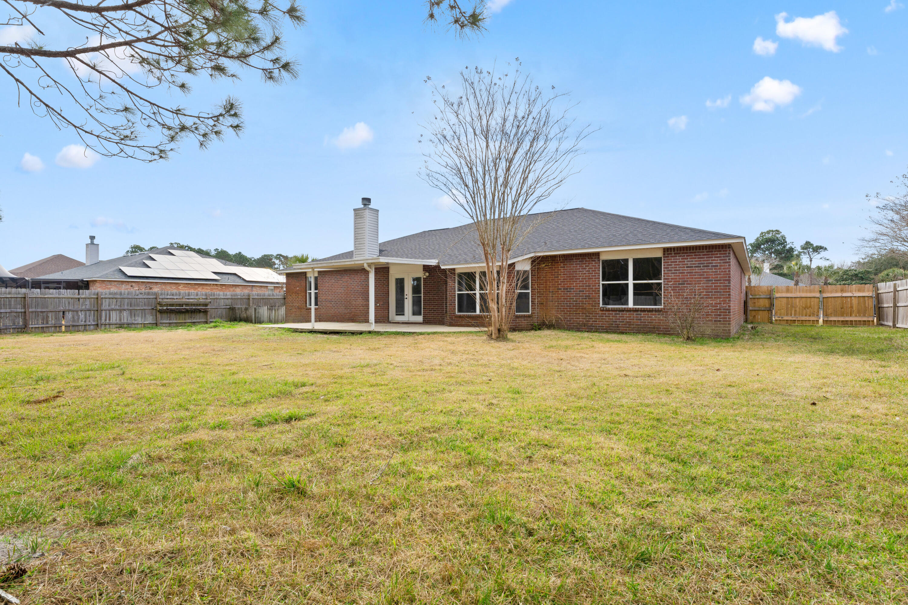 7162 Riverview Road Navarre, FL 32566 - Photo 32 of 33 a front view of a house with a big yard