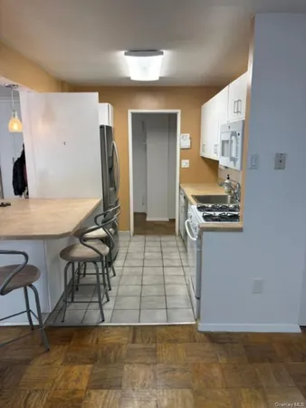 a view of kitchen with furniture and wooden floor
