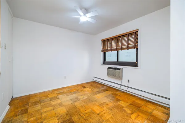 a view of a room with natural light and hardwood floor