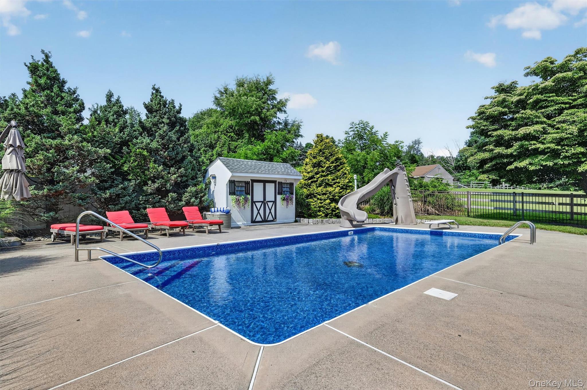 5 Hedges Road Warwick, NY 10990 - Photo 43 of 48 The inground pool features a new liner, generous surrounding patio space, nearby lounge seating, and a pool shed for convenient storage.