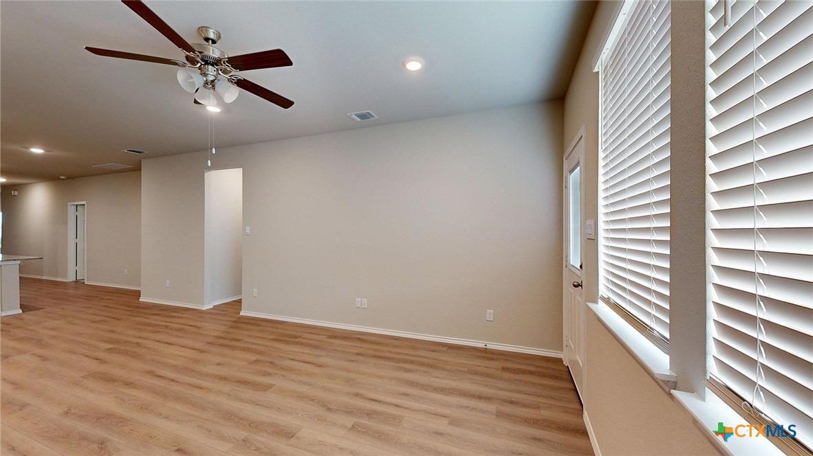 1110 Stone Vly Road Temple, TX 76502 - Photo 13 of 21 an empty room with wooden floor fan and windows