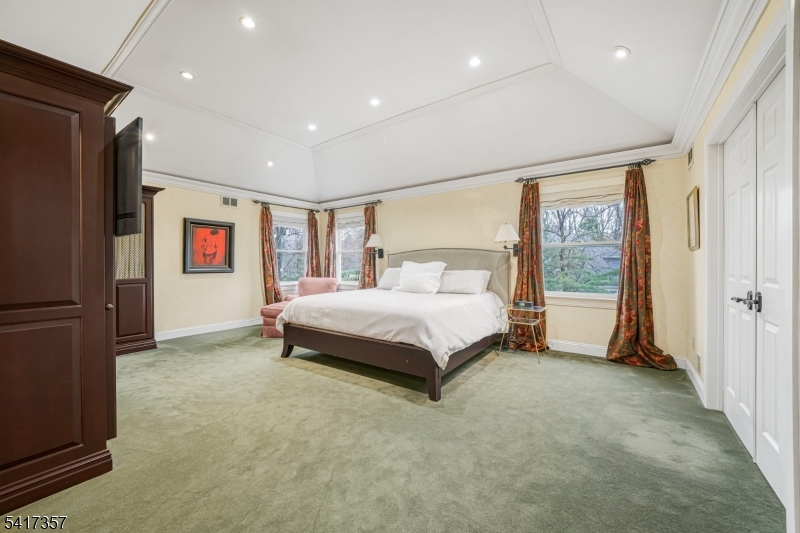 47 Abbott Road Montville, NJ 07082 - Photo 17 of 32 a spacious bedroom with a bed and a refrigerator