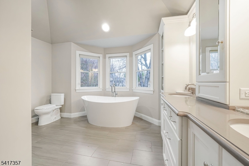 47 Abbott Road Montville, NJ 07082 - Photo 18 of 32 a room with a sink and a large mirror