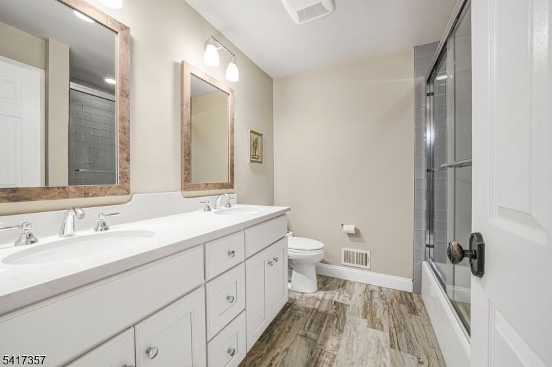 47 Abbott Road Montville, NJ 07082 - Photo 24 of 32 a bathroom with a sink a toilet and a mirror