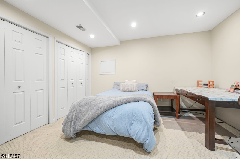 47 Abbott Road Montville, NJ 07082 - Photo 27 of 32 a spacious bedroom with a bed and a table in it