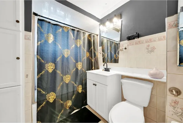 a white toilet sitting next to a bathroom sink