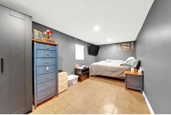 a bedroom with a bed and a couch