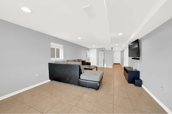 a large bedroom with a bed and a flat screen tv