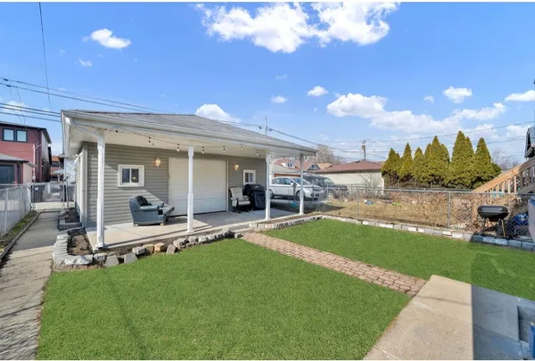 a view of a house with backyard porch and sitting area