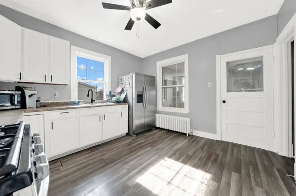 a kitchen with cabinets a sink and wooden floor