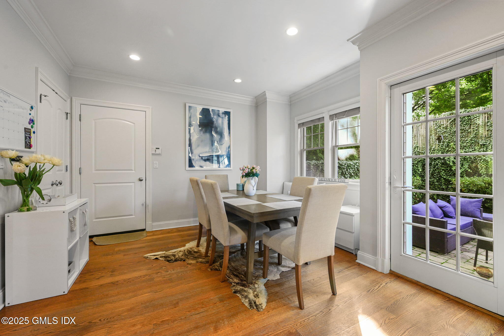 25 Le Grande Avenue, Unit B Greenwich, CT 06830 - Photo 13 of 37 a view of a dining room with furniture and wooden floor